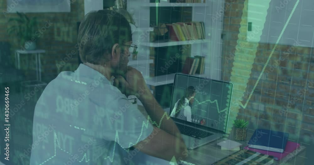 Man sitting at desk in modern office, analyzing laptop screen with animated financial charts Man sitting at desk in modern office, analyzing laptop screen with animated financial charts