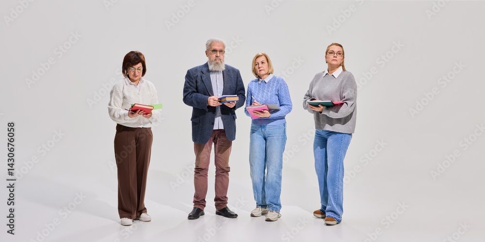 Obraz premium Adult people, pensioners as students standing in a line with books and notes against white background. Elderly students university program. Concept of education for older adults, active aging