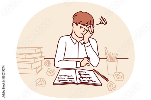 Thinking schoolboy does homework sitting at table with books and workbook after exhausting classes with tutor. Tired schoolboy from elementary school needs rest to replenish strength