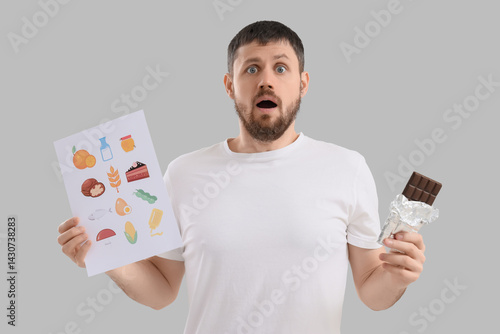 Shocked young man with choc...