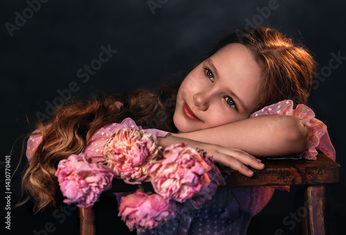 Obraz na płótnie Beautiful girl in a pink dress with a peony flower on a dark background. Romantic, festive image w salonie