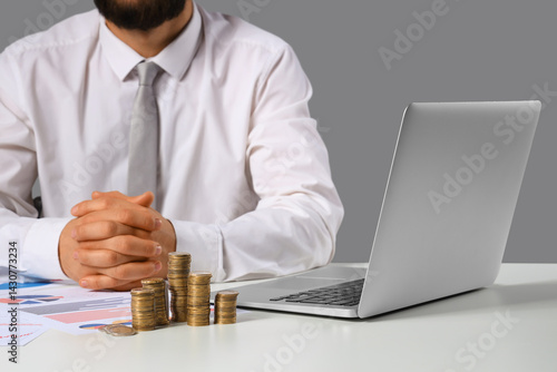 Businessman with coins and ...