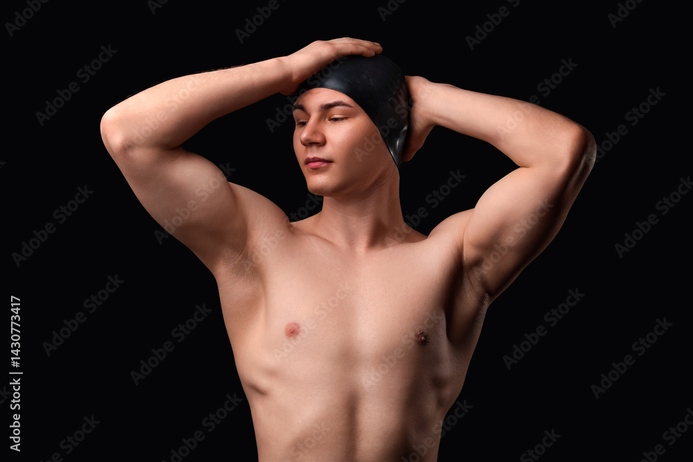 Naklejka premium Male swimmer on black background