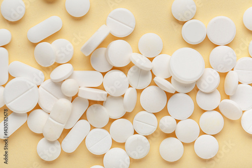 Different white pills on ye...