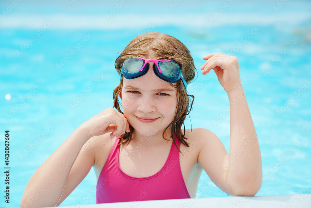 Cute little girl wearing glasses for swimming in the pool.
