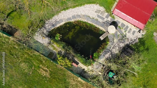 Root wastewater treatment plant as a garden pond. Relaxation zone with fish farming in an organic garden from above. Sustainable development in gardening and aquaculture.