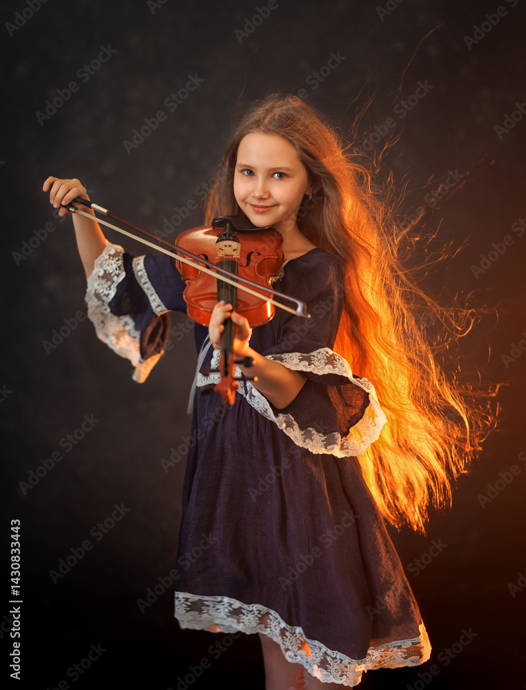 Portrait of a beautiful girl with developing long hair and a violin on a dark background in the studio. Music and art