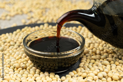 Quadro em tela Close-up of the process of pouring soy sauce into a saucepan.