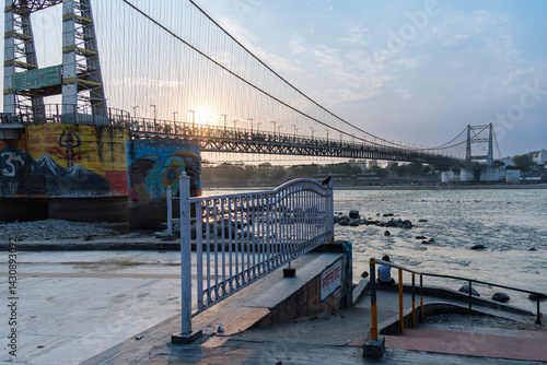 A view of the Janki Setu bridge from across the River Ganges showcases the last pillar of the bridge with the river flowing down. This view is captivating.
