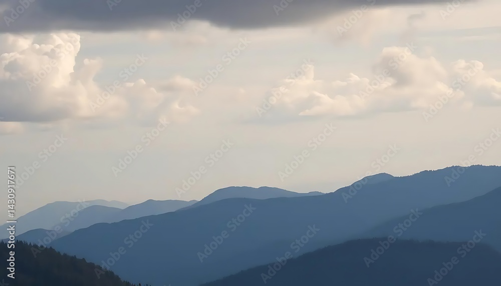 Serene layering: Misty mountain ranges under a cloudy sky scenic vista Serene layering: Misty mountain ranges under a cloudy sky scenic vista