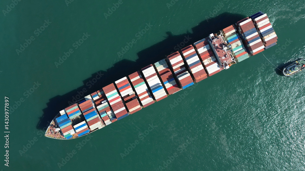 Fototapeta premium Top view of large cargo ship filled with colorful containers