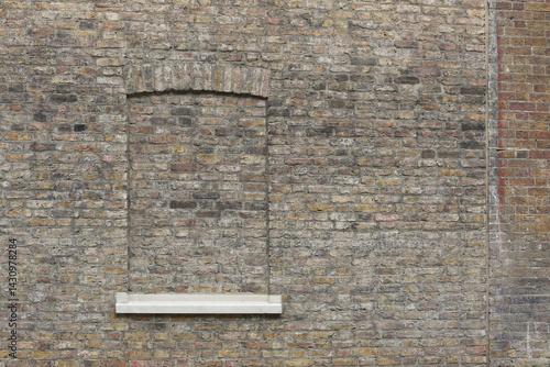 Photography A brick wall with a window bricked up