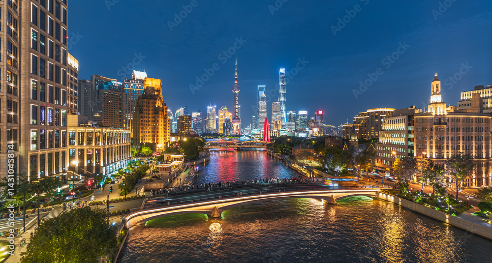 Fototapeta premium Night view of Shanghai cityscape with river, bridge, and skyline light.
