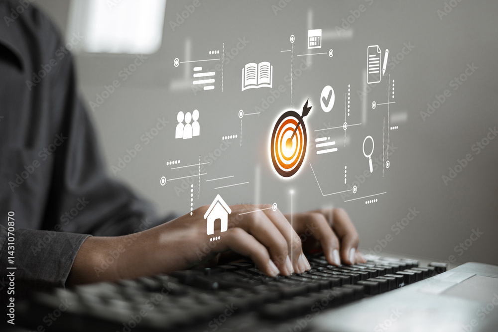 Fototapeta premium A person types on a keyboard while various digital business icons such as a target, documents, and users float in mid-air, representing goals and data management.