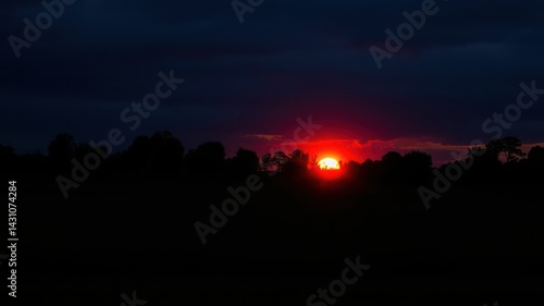 Wallpaper Mural Fiery Sunset Silhouette Over a Dark Treeline at Dusk Torontodigital.ca