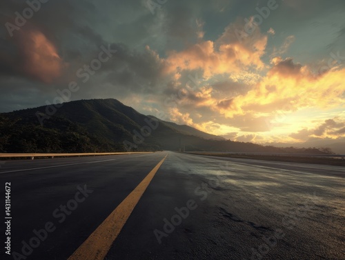 Serene highway road trip at sunset with dramatic clouds and mountain backdrop creating a sense of adventure and freedom on the open road under a colorful sky