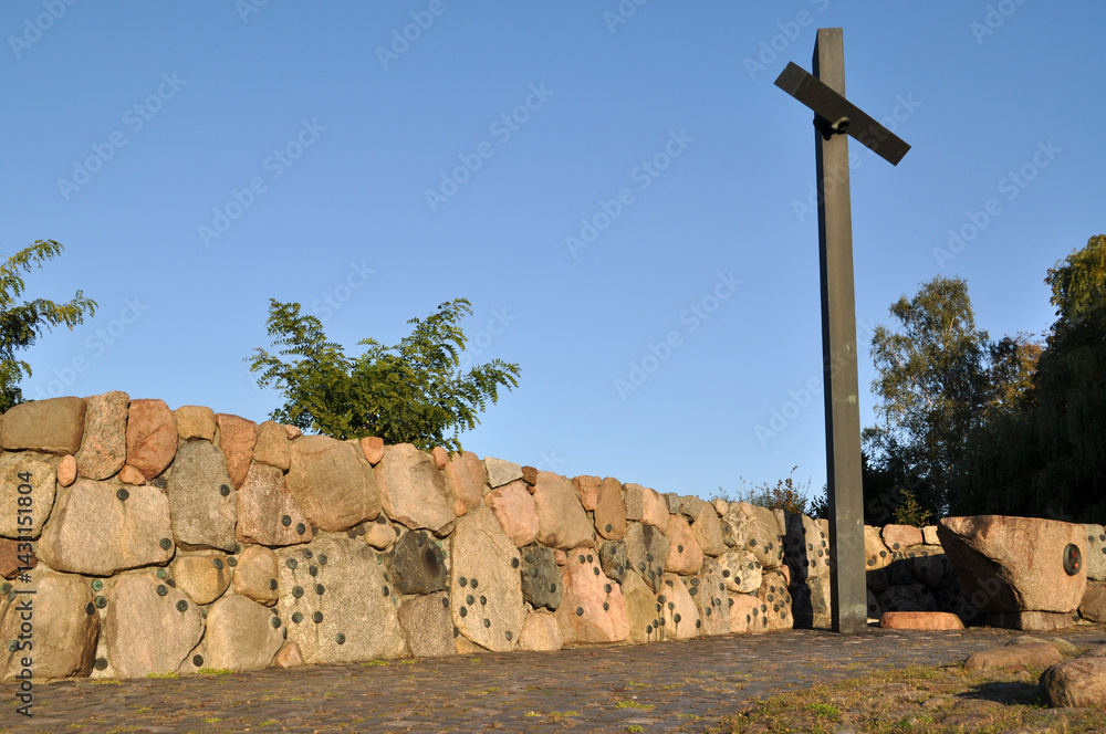 Christian cross high monument in the cemetery stairs