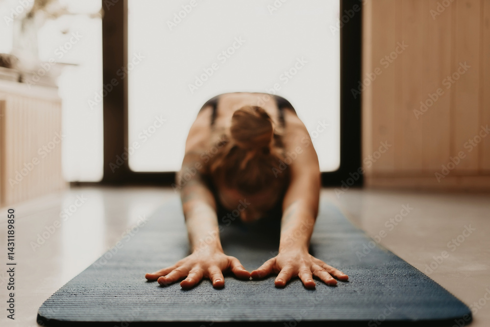 Woman Doing Yoga Stretching in Child Pose