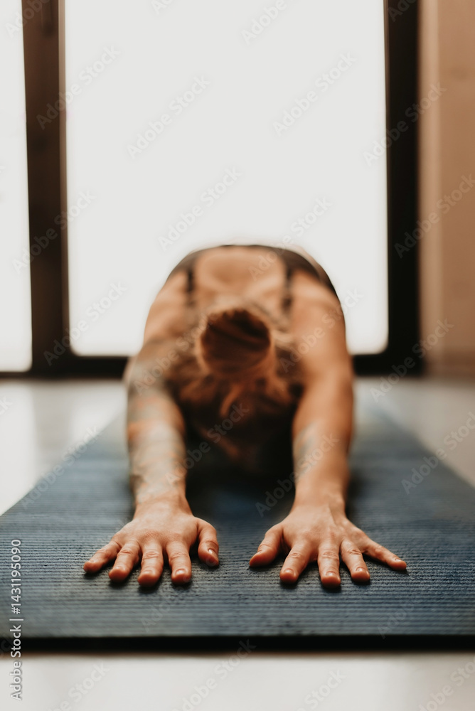 Woman Practicing Yoga Stretching in Child Pose