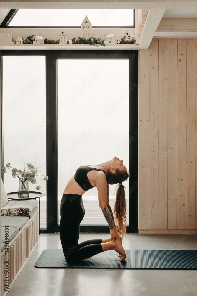 Woman Practicing Yoga Doing Ustrasana Exercise