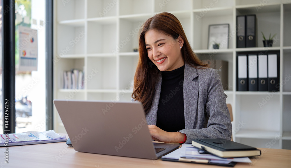 Professional businesswoman working on laptop in bright modern office. Professional businesswoman working on laptop in bright modern office.