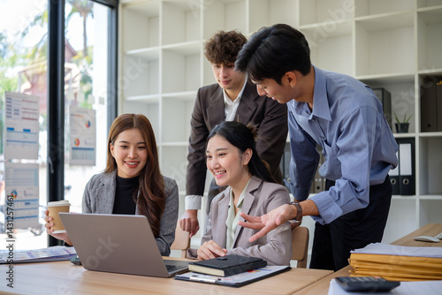 Group of businesspeople brainstorming ideas in bright workplace.
