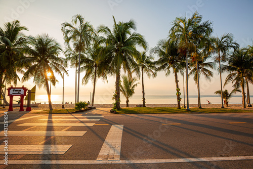 Fototapeta Naklejka Na Ścianę i Meble -  Beach road and coconut trees along the tropical seaside,Beautiful beach road in Thailand