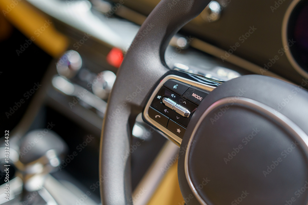 Obraz premium Close-Up of Steering Wheel Control Buttons in a Modern Electric Car