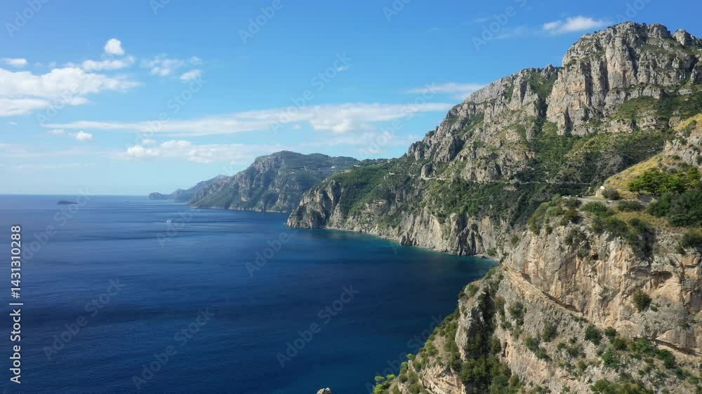 A road winds through the barren hills in Europe, Italy, Campania, in summer, on a sunny day. A road winds through the barren hills in Europe, Italy, Campania, in summer, on a sunny day.