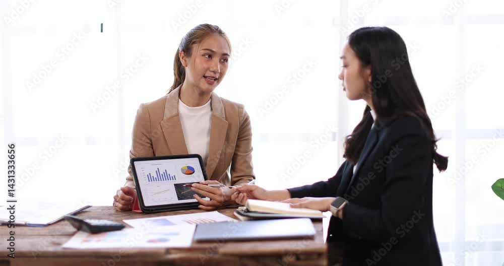 Two business asian women or an accountant team are analyzing data charts, graphs, and a dashboard on a laptop screen in order to prepare a statistical report and discuss financial data in an office
Two business asian women or an accountant team are analyzing data charts, graphs, and a dashboard on a laptop screen in order to prepare a statistical report and discuss financial data in an office