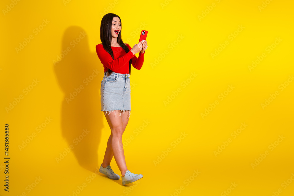 Young lady in vibrant casual outfit taking a selfie against a bright yellow background, expressing happiness and enthusiasm. Young lady in vibrant casual outfit taking a selfie against a bright yellow background, expressing happiness and enthusiasm.