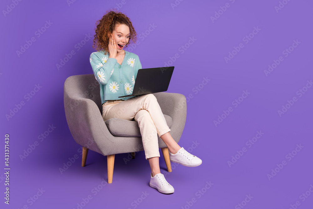 Smiling Woman in Casual Attire Surprised While Using Laptop with Bright Purple Background in a Modern Styled Chair Smiling Woman in Casual Attire Surprised While Using Laptop with Bright Purple Background in a Modern Styled Chair