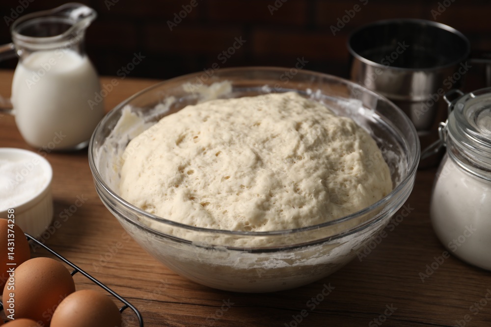 Raw dough and ingredients on wooden table, closeup Raw dough and ingredients on wooden table, closeup