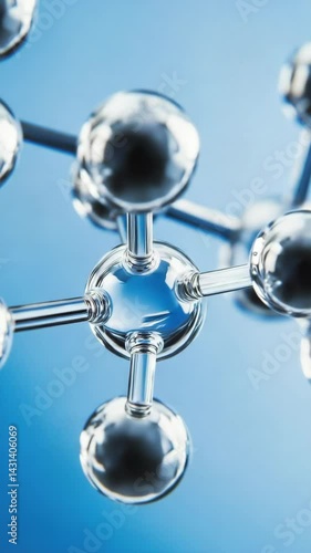 Close-up view of a clear glass molecule structure on a blue background illustrating science and medical research concepts.