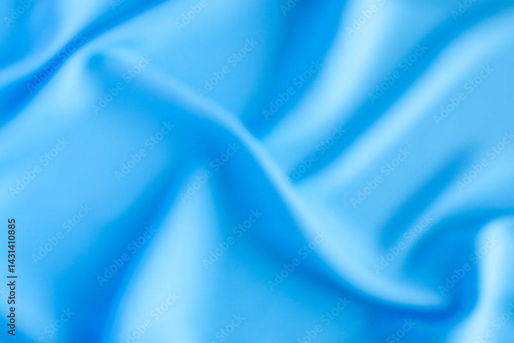 Obraz premium Abstract blurred blue fabric texture with smooth flowing folds