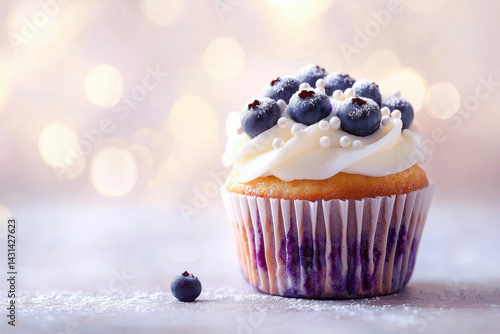 delicious cupcake topped with blueberries, white frosting, and sugar pearls