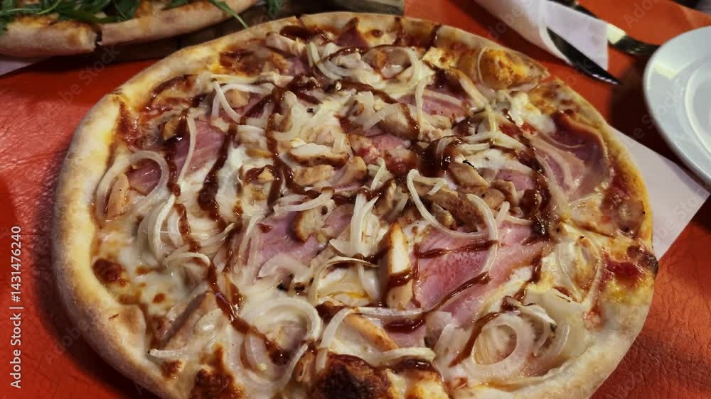 A close-up fresh delicious pizza with ham and onion. Appetizing recipe, Italian cuisine, traditional food concept. High quality 4k footage A close-up fresh delicious pizza with ham and onion. Appetizing recipe, Italian cuisine, traditional food concept. High quality 4k footage
