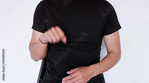 Sign language saying yes. Man wearing a black polo shirt sitting on a white background.
