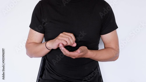 Sign language saying noodles. Man wearing a black polo shirt sitting on a white background.