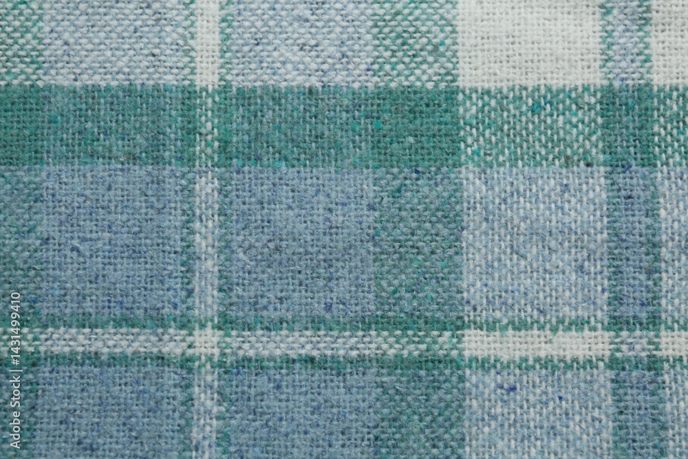 Fototapeta premium Turquoise woolen fabric with geometrical pattern as background, top view