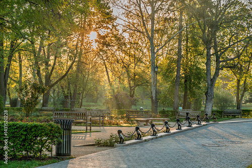 Obraz na płótnie Spring moments in City park of Budapest. Hungarian name is Varosliget. Amazing sunny day with bright lights. The branches of trees are green because many leaves are growing on it. w salonie