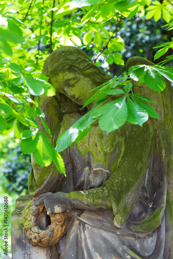 Historic Statue on the spring mystery old Prague Cemetery, Czech Republic 