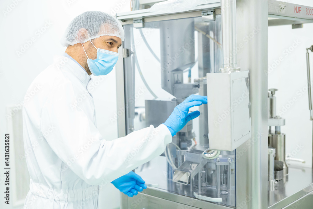 Naklejka premium The technician carefully adjusts the settings on a pharmaceutical machine to ensure proper functioning in the production line.