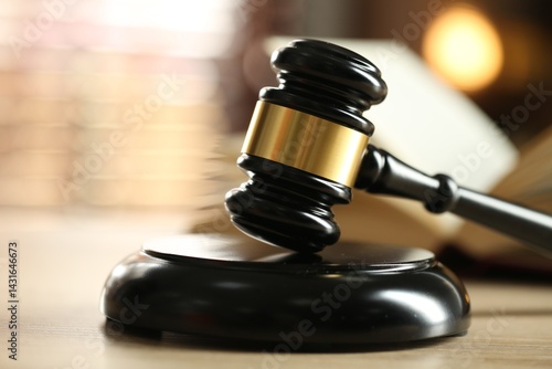 Foto Judge's gavel and book on wooden table indoors, selective focus