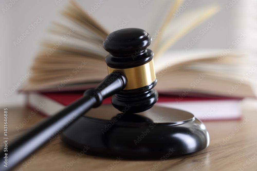 Judge's gavel and books on wooden table indoors, selective focus Judge's gavel and books on wooden table indoors, selective focus