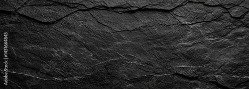 textured black background featuring dark gray rough stone with intricate cracks and lines, creating dramatic and moody atmosphere. This is perfect for various design projects