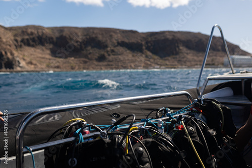 Wallpaper Mural Scuba diving equipment on a boat, ready for underwater exploration near volcanic cliffs Torontodigital.ca