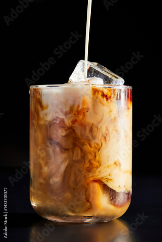 Coffee Pouring into a Glass on a Black Background