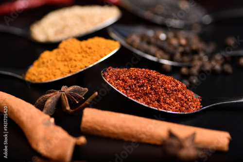 Horizontal group of spices, sesame, pepper, turmeric, cayenne peper