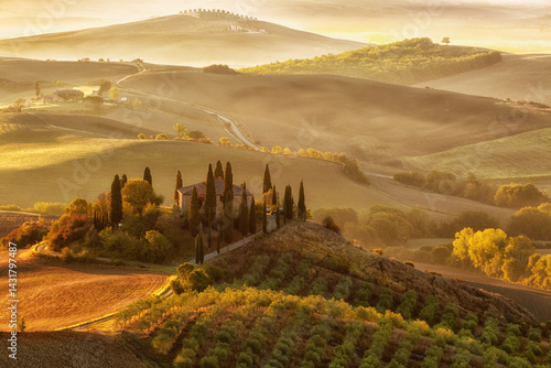 Landscape of hills, country road, cypresses trees and rural houses,Tuscany